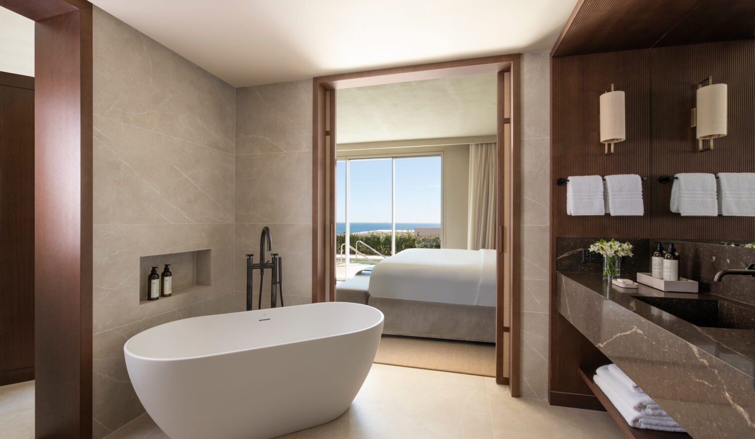 Freestanding bathtub and en-suite bathroom with ocean view at the Fairmont luxury branded residences in Spain