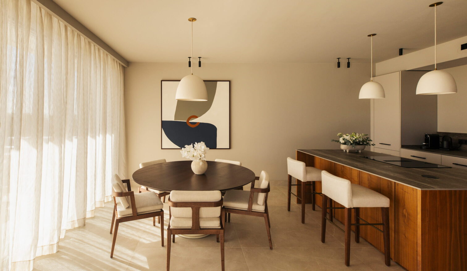 Open-plan kitchen and dining area with designer furnishings in a Fairmont luxury branded villa suite